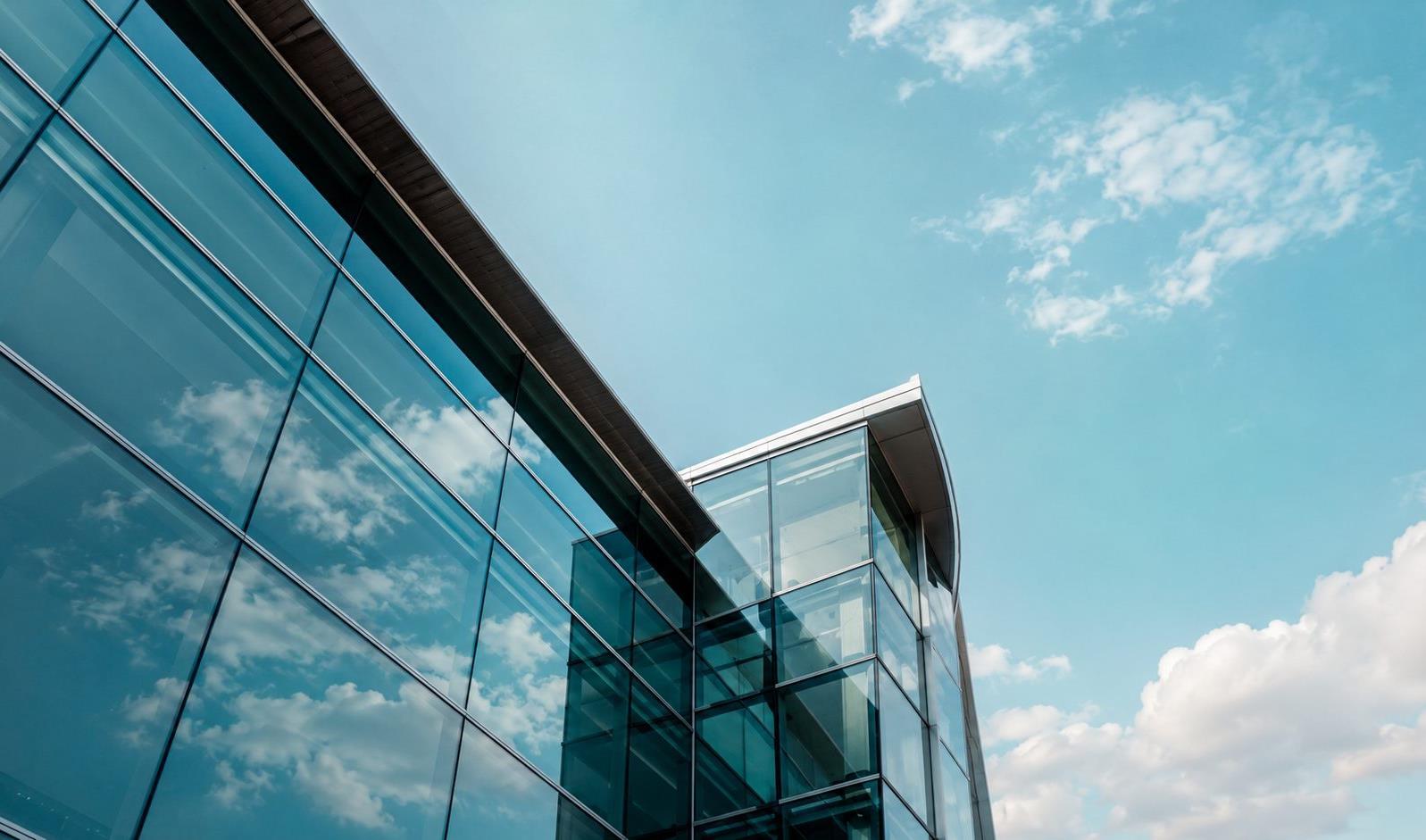 Looking upward along the clean glass lines of a contemporary commercial building